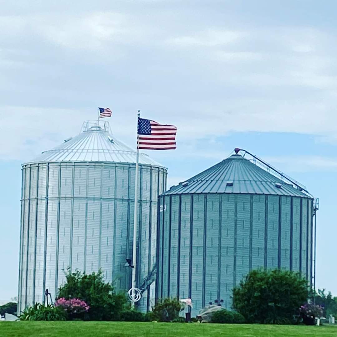 2 silos with american flag in the middle